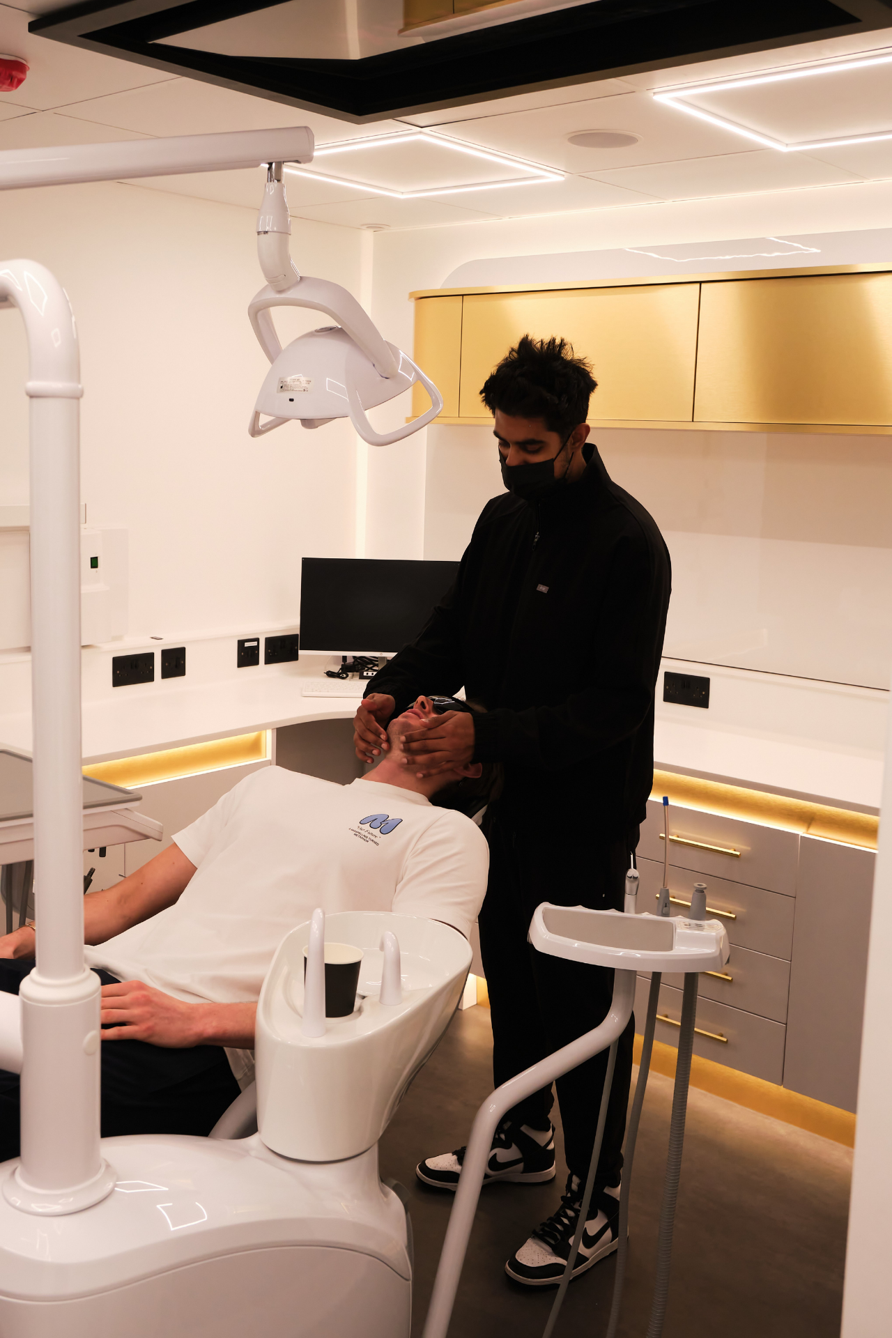 Dr Jam with a patient during a check-up at Smile Showroom